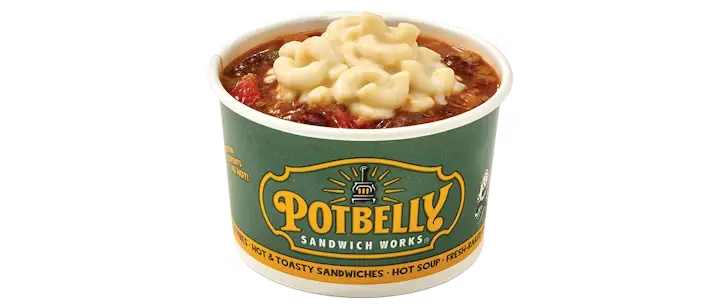 A warm Potbelly Menu item, the Potbelly Chili Mac, featuring a hearty bowl of beef chili with kidney beans, bell peppers, and onions, topped with creamy three-cheese mac and cheese, served with a spoon against a black background, priced at $5.49 with 300 calories.