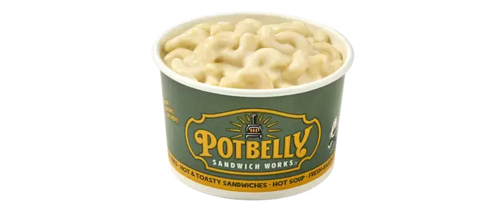 A comforting Potbelly Menu item, the Potbelly Mac & Cheese, featuring a creamy bowl of three-cheese mac and cheese with a golden top, served in a branded green cup against a black background, priced at $5.49 with 297 calories.