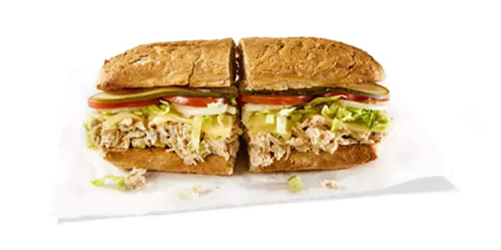 A fresh Potbelly Menu item, the Tuna Salad, featuring a toasted sub roll filled with 100% albacore tuna salad, melted Swiss cheese, crisp lettuce, tomatoes, and pickles, cut into portions and served on white paper against a black background, priced at $10.89 with 685 calories.